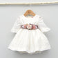 Vestido niña plumeti Isabel con adorno floral